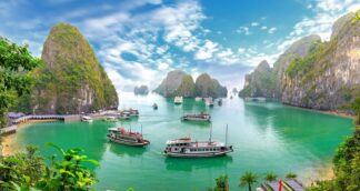 Ha Long Bay Vietnam with limestone cliffs and boats on emerald water – women-only group travel adventure.