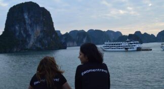 Two women travellers enjoying the scenic views of Ha Long Bay during a women-only Vietnam group tour with Jugni Travel.