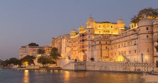This picture shows Udaipur city at twilight time. Udaipur city palace was built over a period of nearly 400 years being contributed by several kings of the dynasty. It is located on the east bank of the Lake Pichola and has several palaces built within its complex.