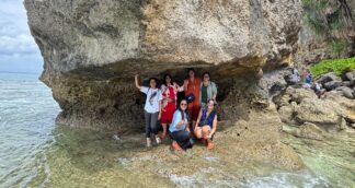 A group of women pose for a picture at a beach in the Andaman Islands
