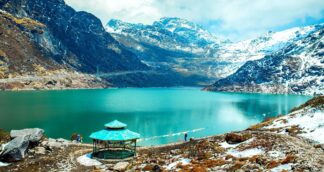 Tsomgo Lake in Sikkim surrounded by snowy mountains during the Sikkim women only group trip