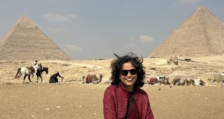 Jugni women-only Egypt tour traveller seated before the Giza pyramids in Cairo