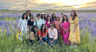 Women-only travel group enjoying sunset in lavender fields during Kyrgyzstan and Kazakhstan group trip by Jugni Travel