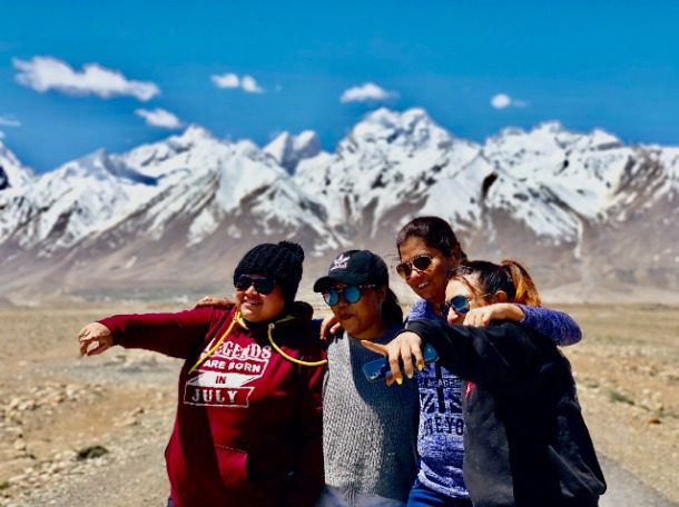 Solo women travellers with Jugni Travel enjoying the snow-capped mountains on a women-only group trip in 2026