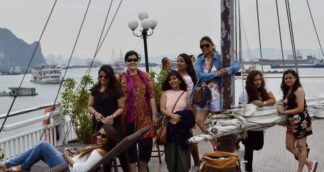 Group of solo women travellers from Jugni Travel enjoying a cruise experience during a Vietnam trip.