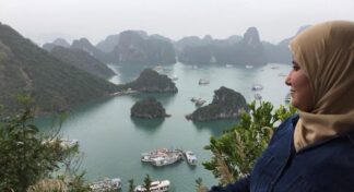 Woman enjoying the panoramic view of Halong Bay during a Jugni women-only Vietnam trip.